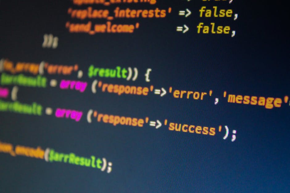 Close-up image of a computer screen displaying lines of programming code with syntax highlighting. The code features various keywords and functions in different colors, including orange, yellow, pink,